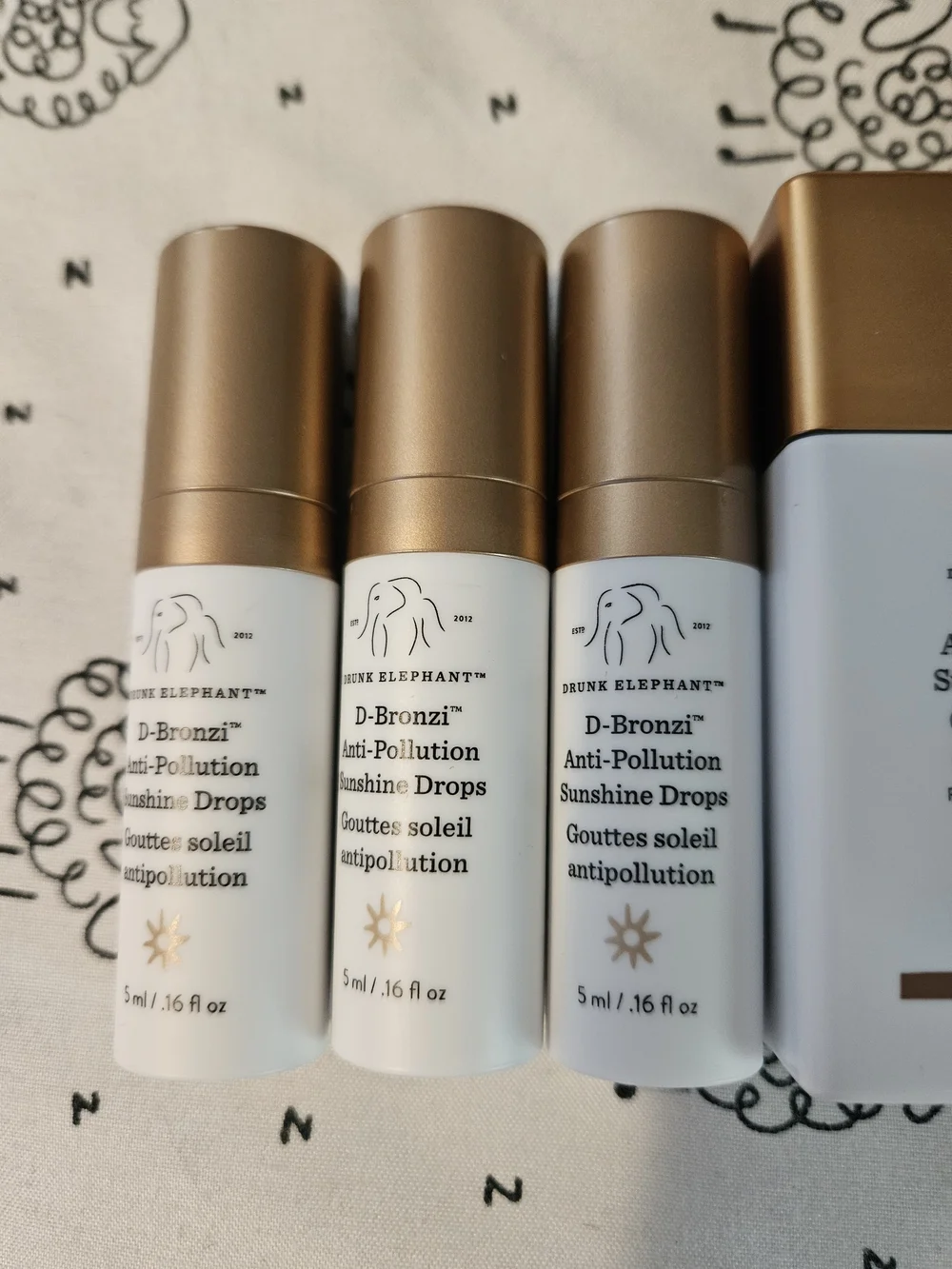 Drunk Elephant D-Bronzi Sunstick — White & Gold